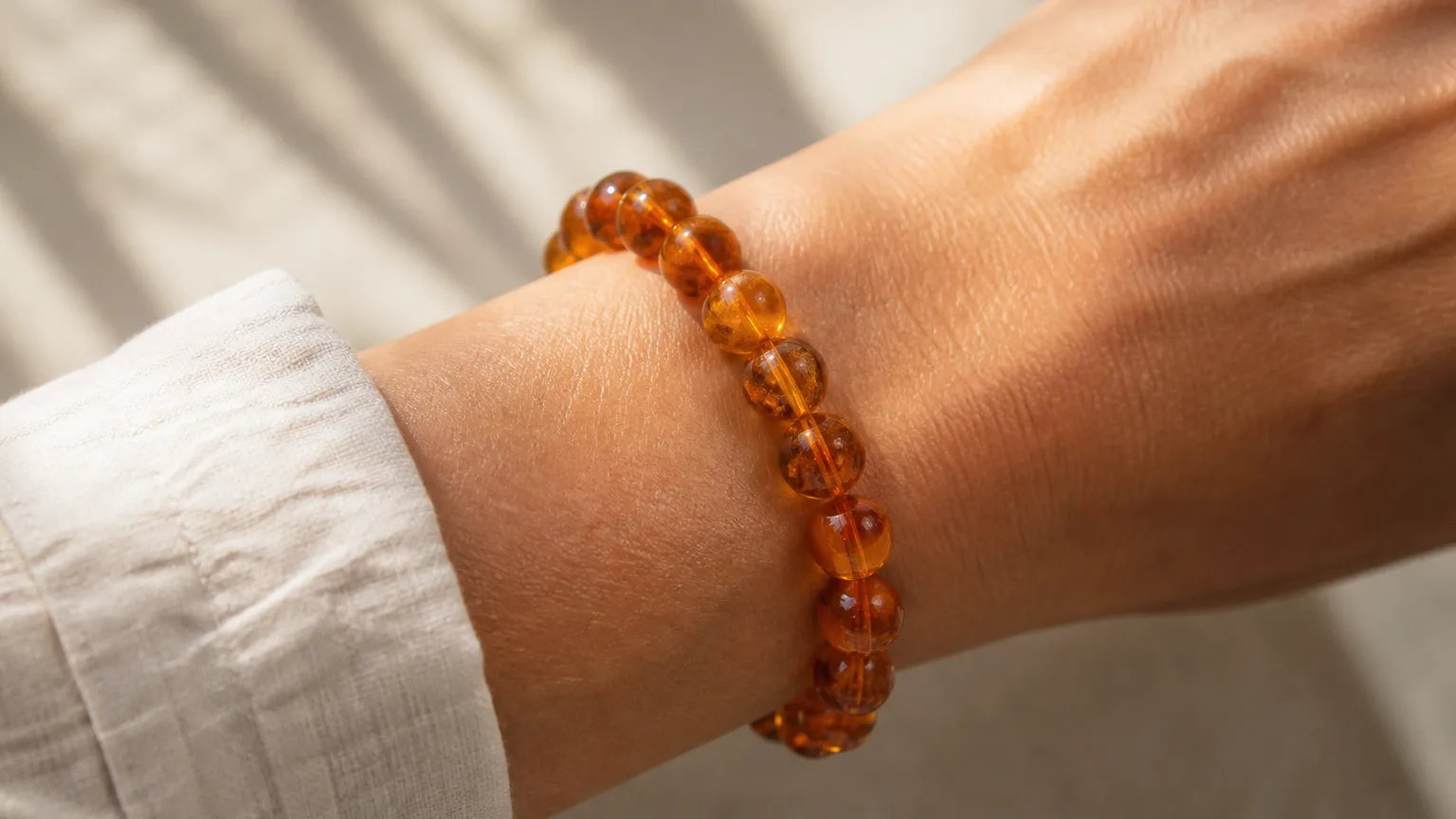 Amber bead bracelet worn on the wrist for daily warmth
