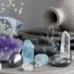 Best crystals for Aquarius: Amethyst, Aquamarine, Hematite, Clear Quartz and more arranged with an Aquarius water bearer motif