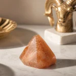 Aries August 2026 monthly horoscope with Sunstone as crystal of the month, zodiac symbol ♈