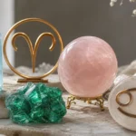 Aries and Cancer compatibility with Aquamarine, Emerald, and Rose Quartz crystals arranged with zodiac symbols ♈ and ♋