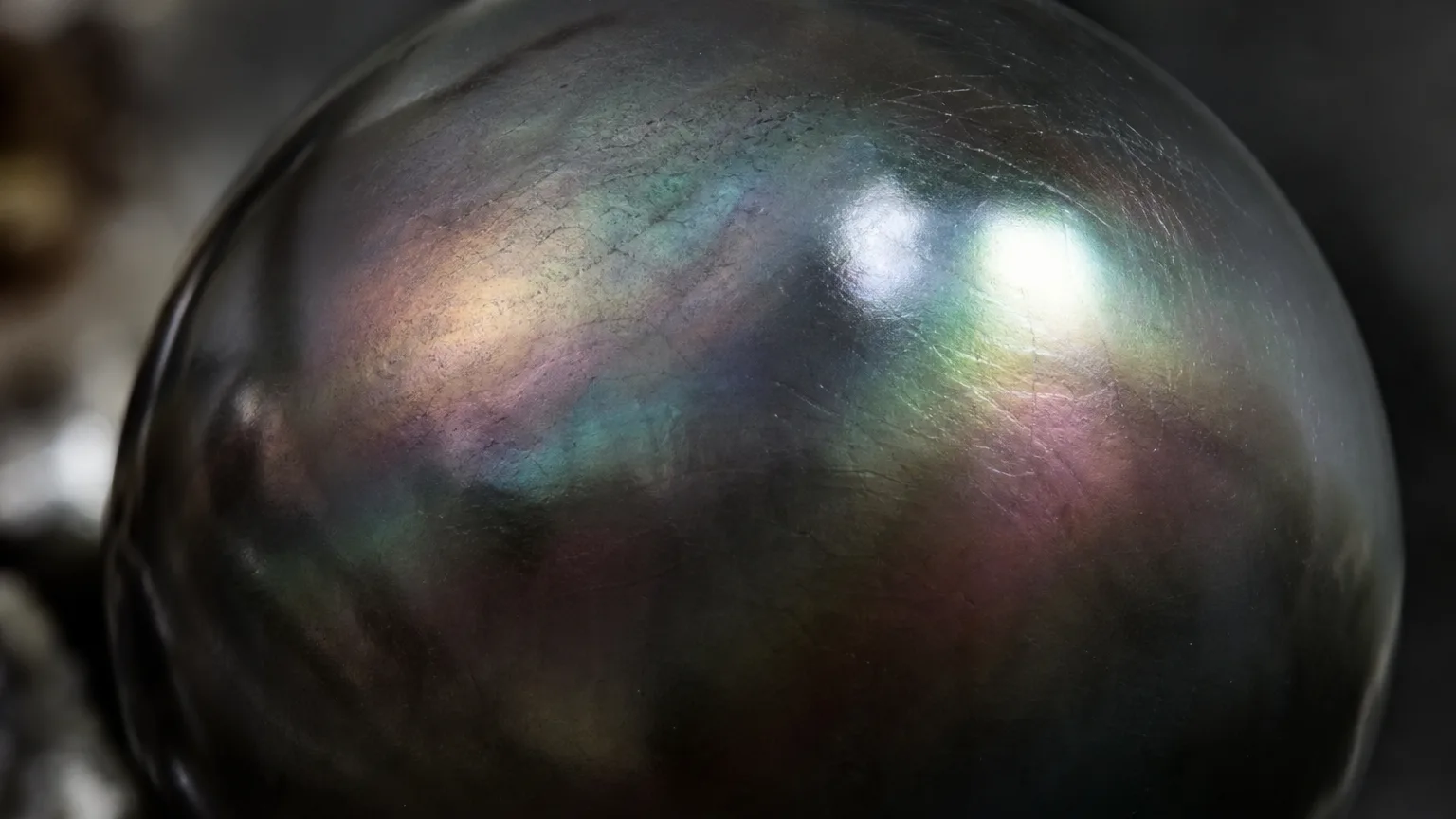 Black Pearl Meaning: Healing Properties & Uses 2 Black pearl dark iridescent nacreous surface close-up