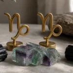 Capricorn and Capricorn compatibility with Black Tourmaline, Fluorite, and Black Tourmaline crystals arranged with zodiac symbols ♑ and ♑