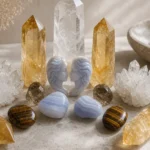 Best crystals for Gemini: Citrine, Clear Quartz, Blue Lace Agate, Tiger's Eye and more arranged with a Gemini twins motif