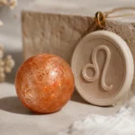 Leo 2026 yearly horoscope with Sunstone as crystal of the year, zodiac symbol ♌, representing creativity, self-expression, and personal power