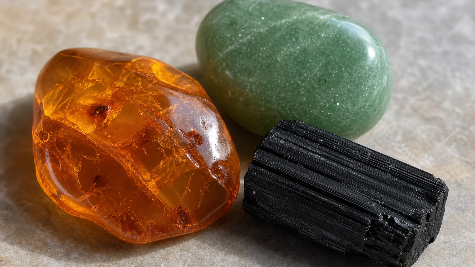 The best crystal pair for Leo and Leo: Amber, Aventurine, and Black Tourmaline shown together