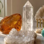 Leo and Virgo compatibility with Amber, Amazonite, and Quartz crystals arranged with zodiac symbols ♌ and ♍