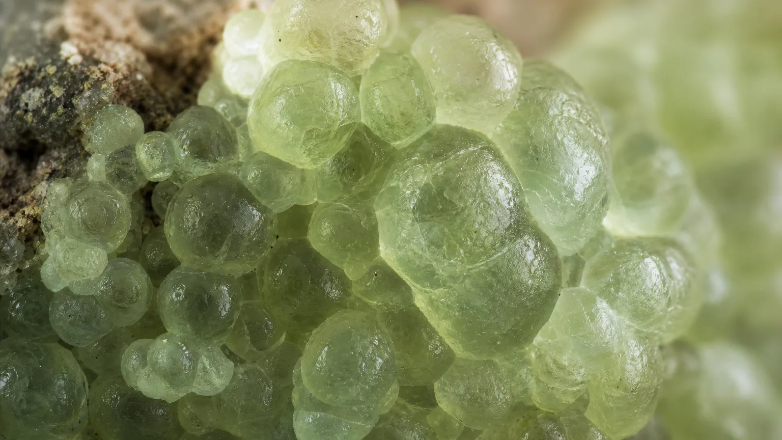 Prehnite Meaning: Healing Properties & Uses 2 Prehnite pale green botryoidal grape-like surface close-up
