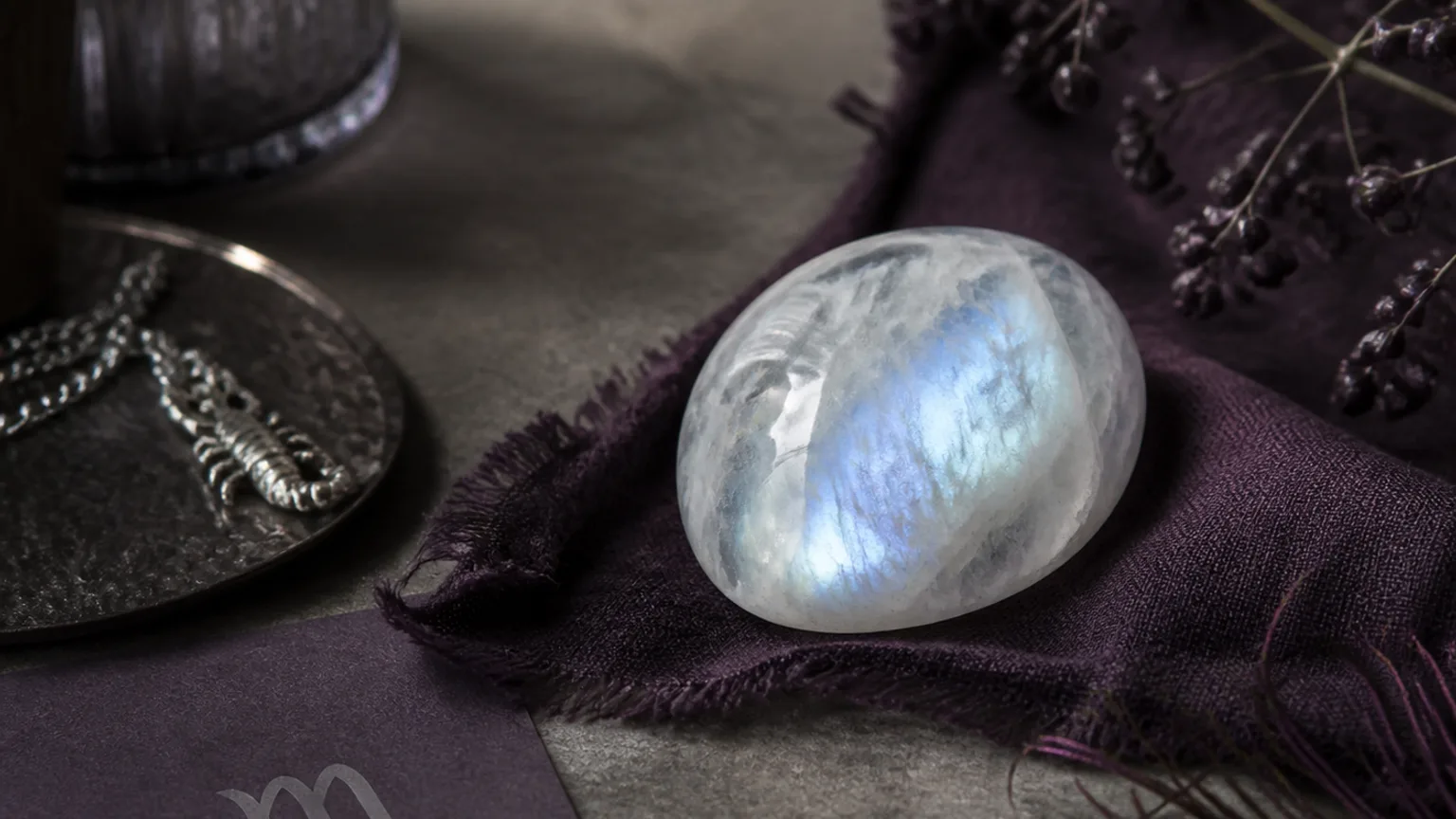 Scorpio June 2026 monthly horoscope with Moonstone as crystal of the month, zodiac symbol ♏