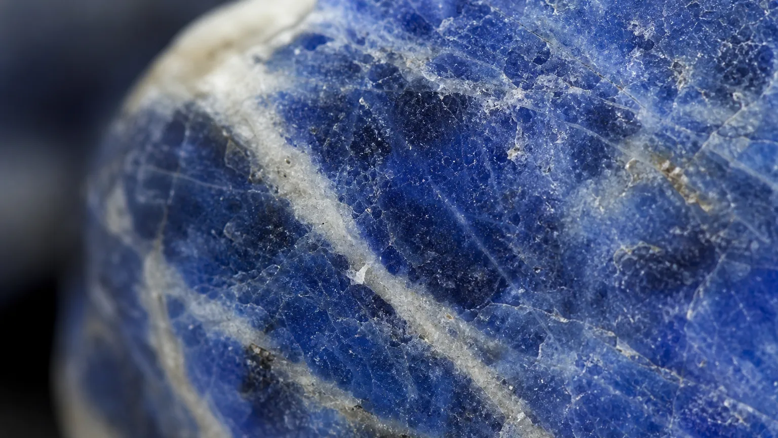 Sodalite Meaning: Healing Properties & Uses 2 Deep blue sodalite white calcite streaks close-up