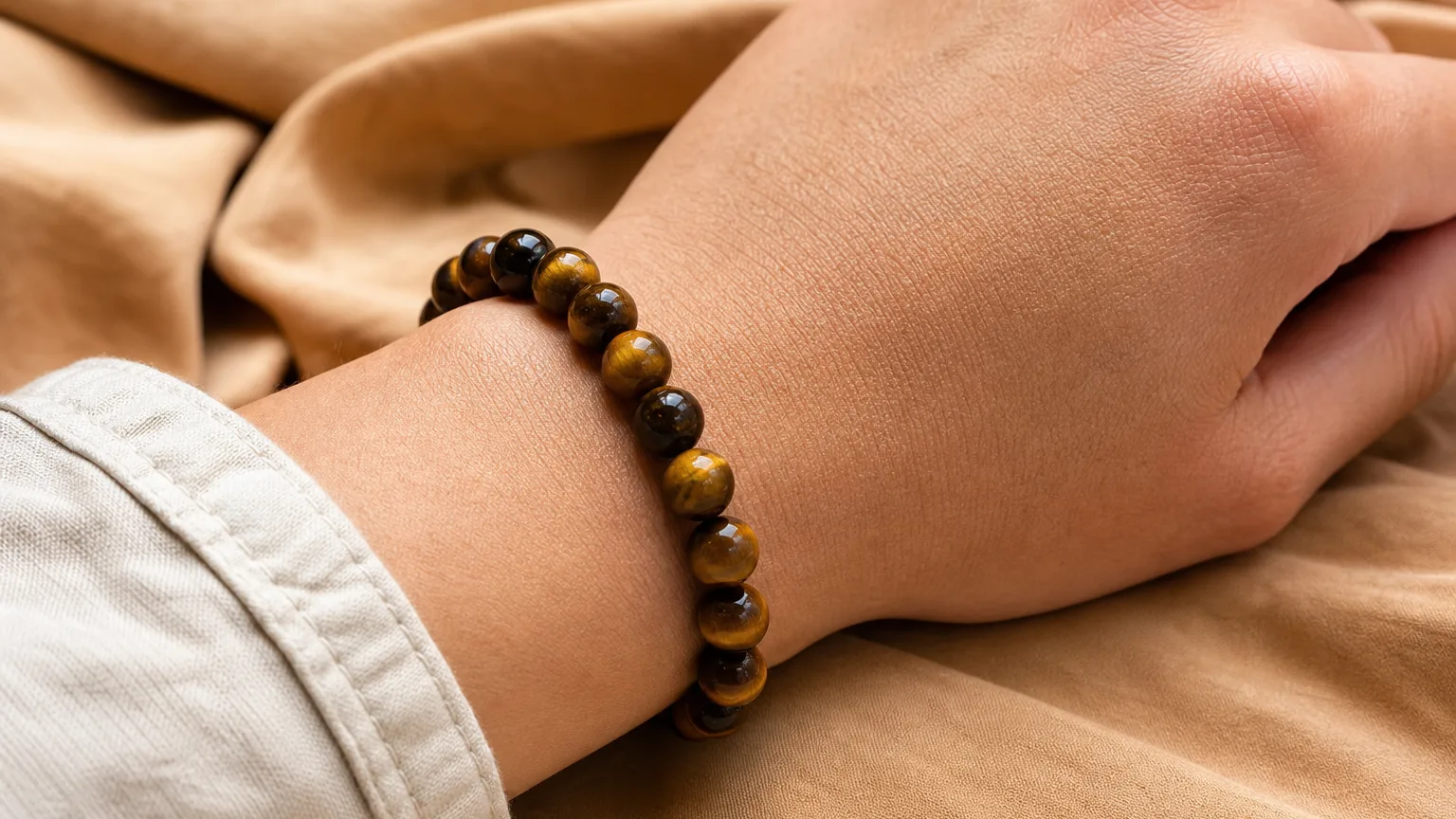 Tiger Eye Meaning: Healing Properties & Uses 5 Tiger eye bracelet worn on the wrist for daily use