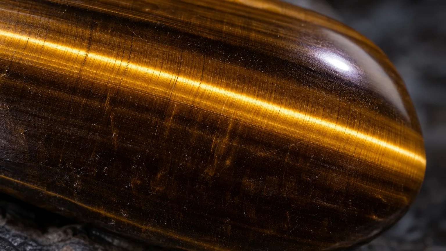Tiger Eye Meaning: Healing Properties & Uses 2 Tiger eye golden chatoyant band close-up