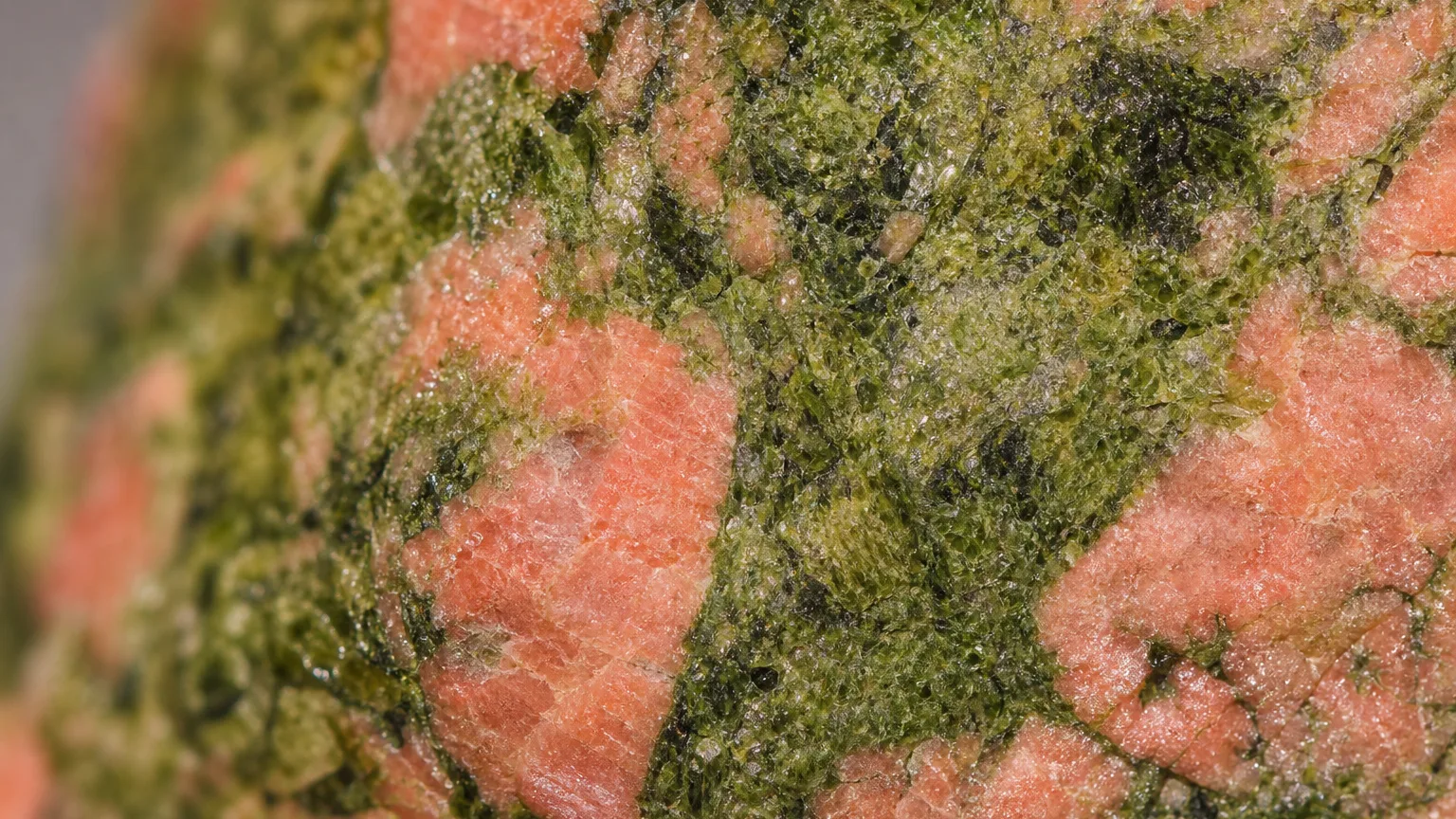 Pink-green unakite epidote feldspar texture close-up