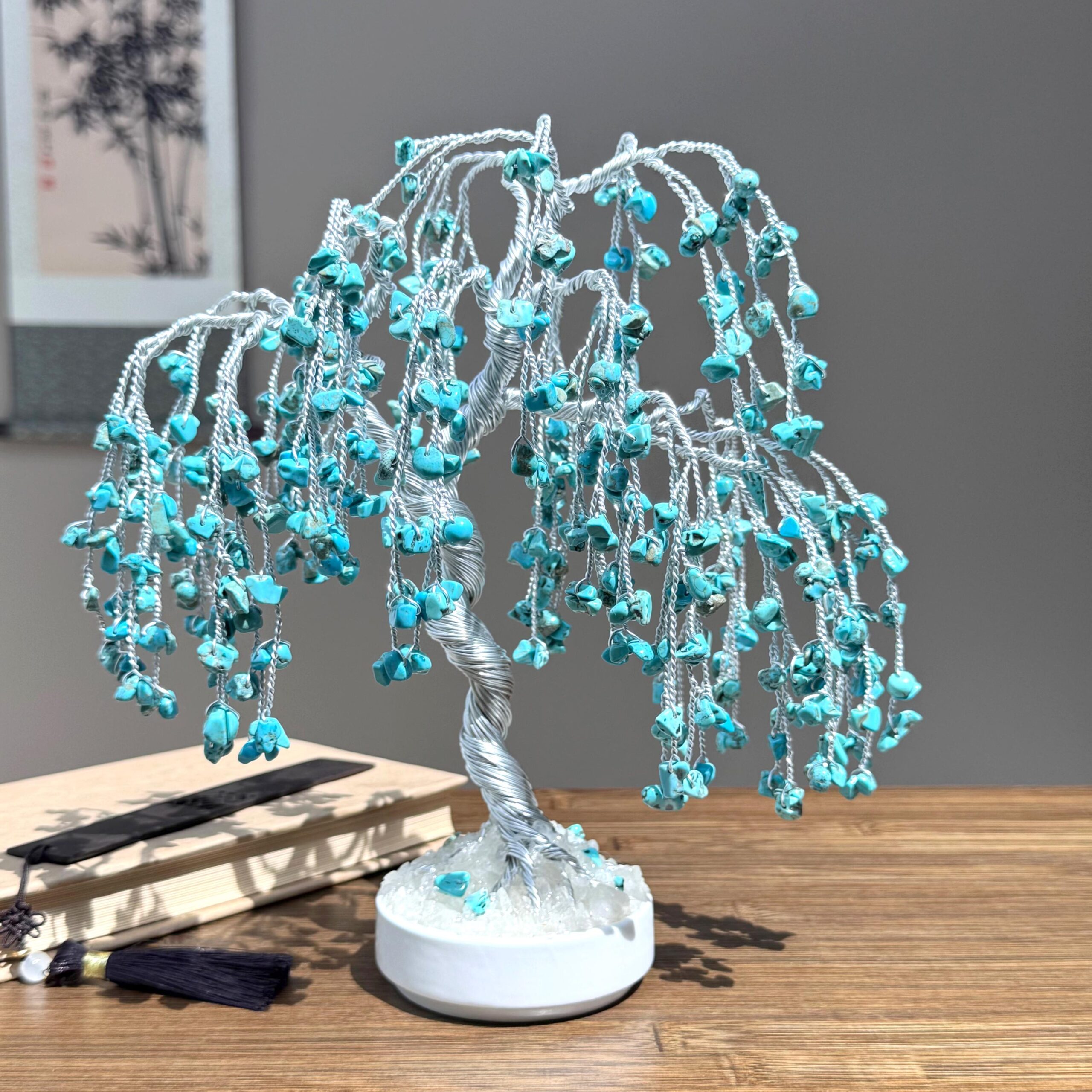 Natural Turquoise Willow Tree - Image 1 May include: A decorative wire tree sculpture with a silver-colored trunk and branches. The branches are adorned with small, turquoise-colored stones, creating a cascading effect. The tree sits on a white base, and the overall design resembles a weeping willow.