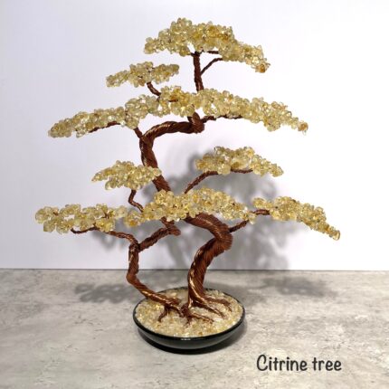 May include: A citrine gemstone tree with a copper wire base and a black pot. The tree is made of many small citrine stones and has a natural, organic shape. The tree is a popular decor item for homes and offices.